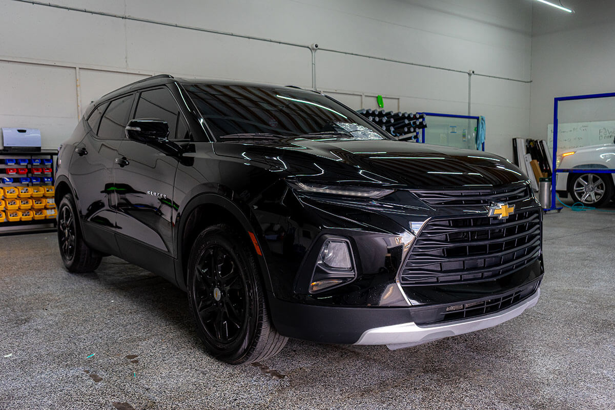 Multi-year tier 3M ceramic coating applied to a sedan during a Polar Tint Certified install — water-beading hydrophobic finish curing on factory paint