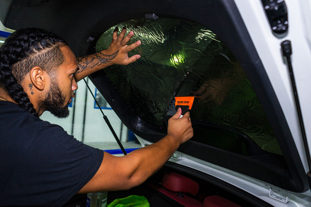 Premium ceramic window tint applied to a sedan rear window during a Polar Tint Certified install