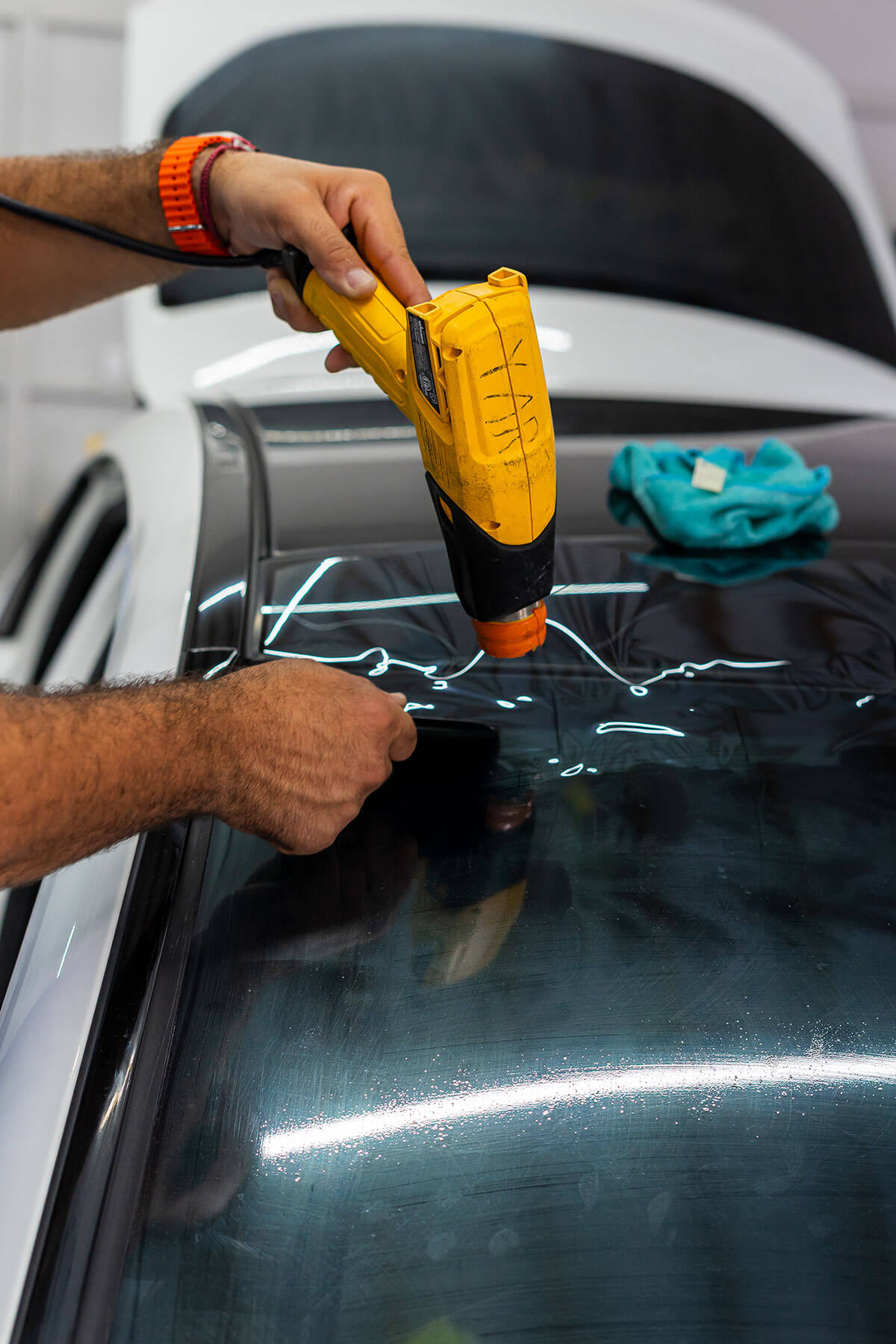 Ceramic Ultimate Plus 98% IR window tint installed on a luxury vehicle during a Polar Tint Certified bay session